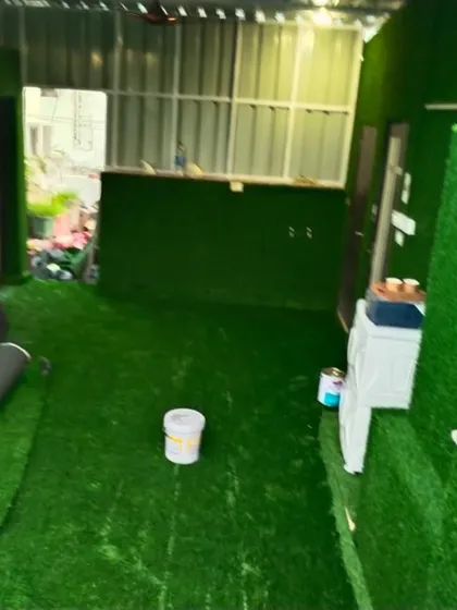The work in progress for the full-room grass installation.