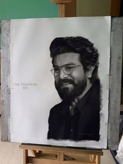 Here is the finished portrait of Ram Charan, seen on the easel in my studio. This view shows the artwork as a physical object, taped to the board, giving a sense of the creative process before it is framed.