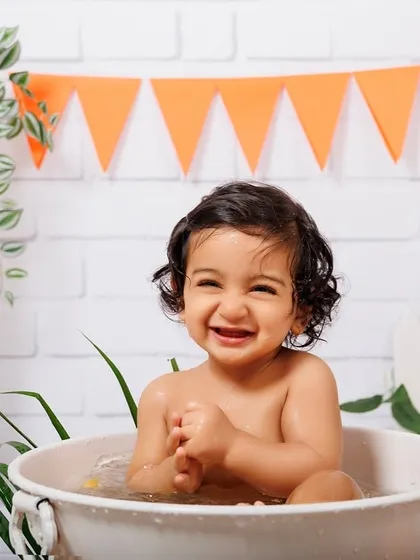 The happiest smile from a baby boy during his super fun and splashy tub time photoshoot.