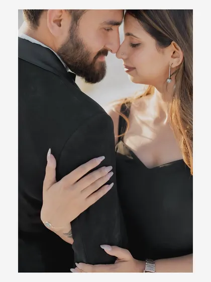 A close-up, intimate portrait of a couple, capturing the soft light and their gentle expressions during a desert pre-wedding shoot.