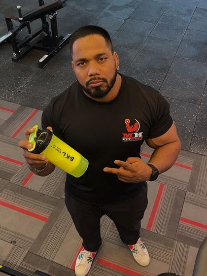 Holding my shaker. The supplements I recommend are the ones I trust and use myself every day.