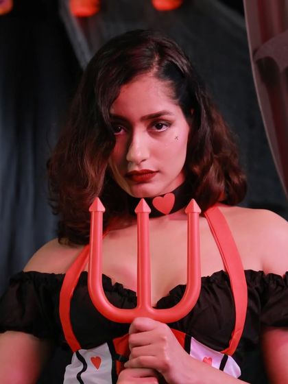 A closer look at our Queen of Hearts costume. The outfit comes with a trident prop and a heart choker, adding those perfect finishing touches to your villainous look.