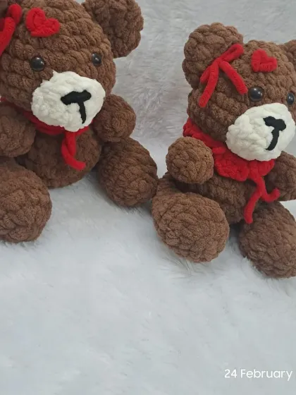 A pair of brown teddy bears made from extra soft plush yarn, perfect for Valentine's day with their little red hearts.