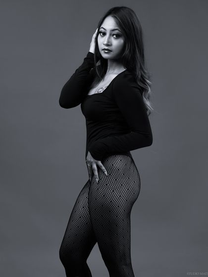 A three-quarter length black and white portrait, with a classic and timeless feel.