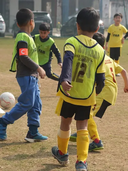 Young players in a match. We believe football is a journey we embark on together, fostering a sense of community and teamwork.