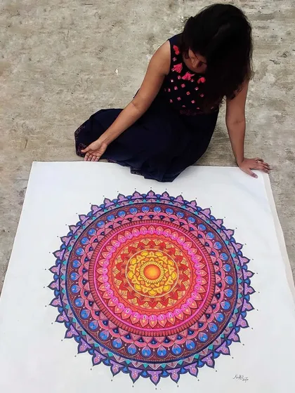 Here I am with a huge, custom-painted mandala on canvas. I love working on a large scale to create a truly immersive piece of art that becomes the centerpiece of any room.