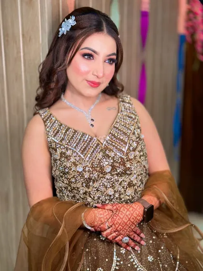 Our beautiful engagement bride Kavya. We created a soft, romantic look with wavy hair and a subtle pink lip to match her brown lehenga.