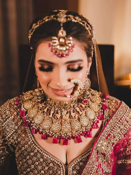 A close-up of a bride wearing a magnificent, oversized polki and ruby necklace. This piece is for the bride who wants to make a bold statement.