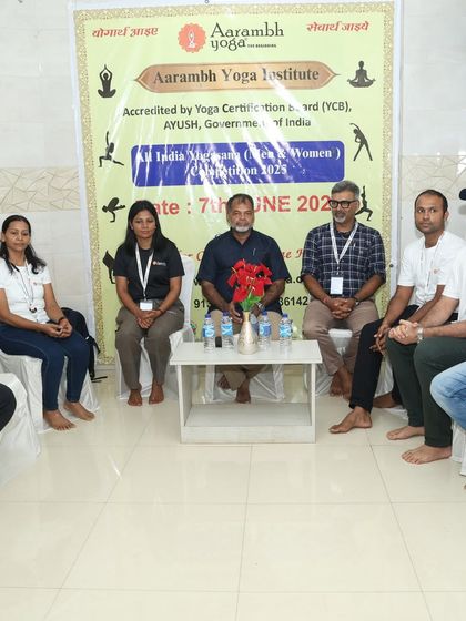 The judges and chief guest seated together, ready for the yogasana competition to begin.