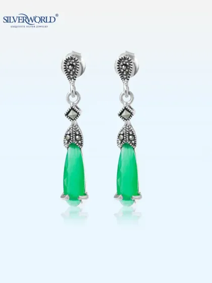 These dangling earrings feature a faceted green gemstone drop with vintage-style marcasite detailing. They offer a touch of old-world charm and elegance.