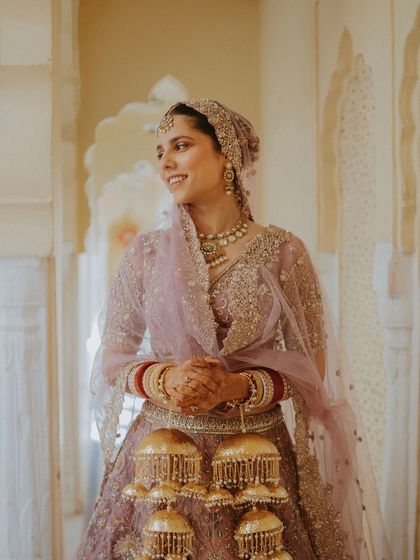 A candid portrait of a Sikh bride in her lavender lehenga, her smile radiating happiness.