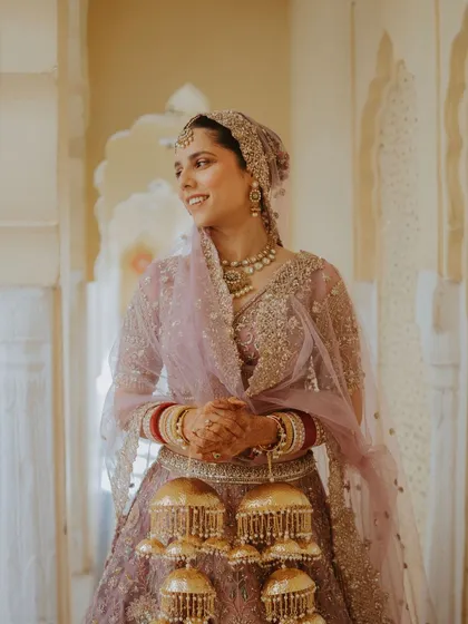 A candid portrait of a Sikh bride in her lavender lehenga, her smile radiating happiness.