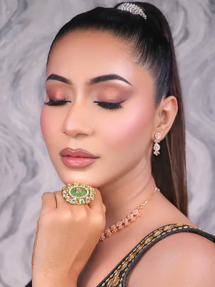 An elegant and subtle makeup look, perfect for a sophisticated party or event. The soft brown smokey eye and nude lip create a timeless and graceful appearance.
