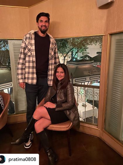 A couple enjoying a birthday celebration in our upstairs dining area, with a view of the terrace below.