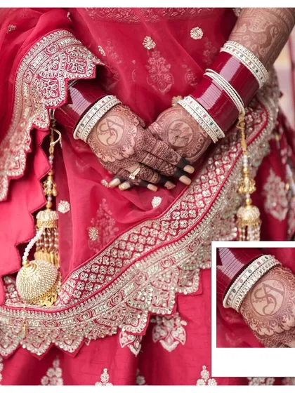 A detailed shot of the bride's hands, showcasing her intricate henna design and the traditional chooda. These details are an important part of the bridal story.