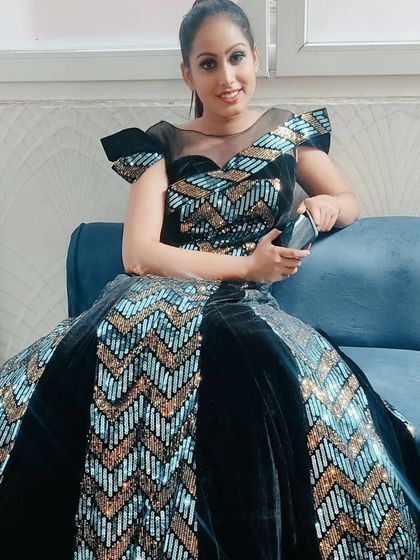 A seated view of the chevron sequin gown, showing its volume and how comfortable it is for any event.