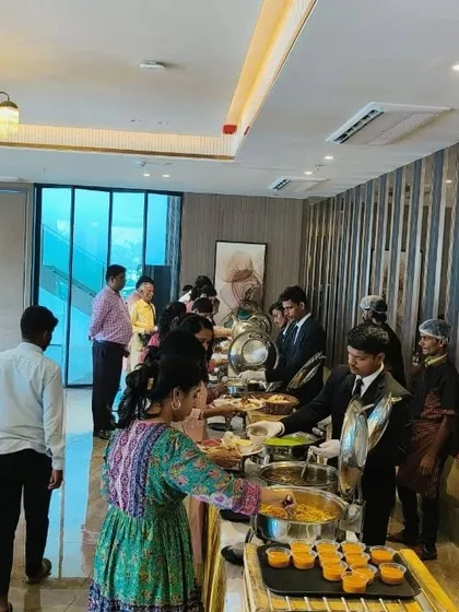 Guests love the experience of a live buffet. Here, our team is serving a variety of dishes, including live counters for Hakka Noodles and Thai Curry, at a house warming party.