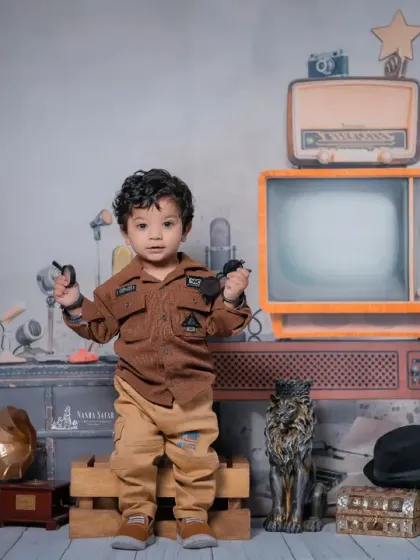 Ready for his broadcast. This full-body shot shows the baby standing tall amidst the vintage equipment, creating a powerful and cute image.