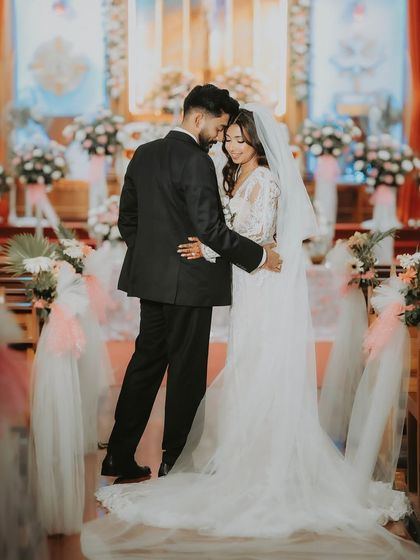 A full-length portrait of the couple inside the church after their ceremony. This shot captures the beautiful setting and the quiet moments that follow the vows.