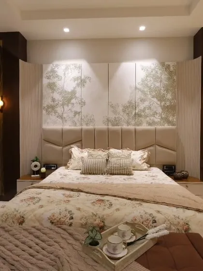 For this master bedroom in Delhi, the goal was timeless tranquility. I used a soft, neutral palette, a custom upholstered headboard with nature-inspired panels, and layered lighting to craft a warm, refined sanctuary that feels like a lasting comfort.