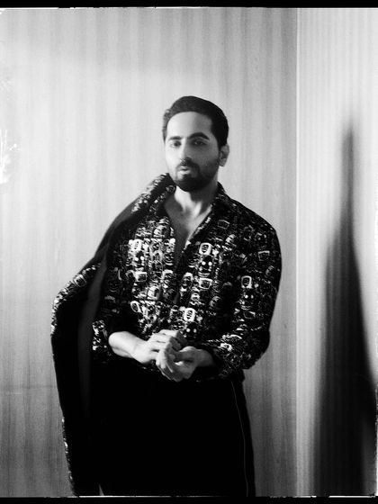 Another powerful black and white shot of Ayushmann Khurrana, capturing his dynamic presence as he adjusts his jacket.