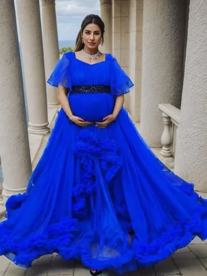 Make a bold and beautiful statement with our royal blue ruffle gown. The vibrant color and cascading layers of tulle create incredible volume and texture, ensuring you stand out in every single photo.