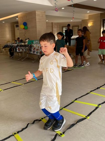 A young participant showing off his moves on the indoor agility ladder. We encourage every child to try their best and have fun with the process.