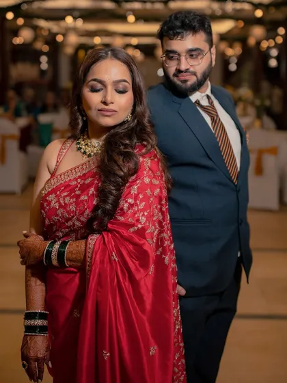 A quiet, romantic moment amidst the celebration. The soft lighting highlights the beautiful brown smokey eye and the bride's radiant complexion.