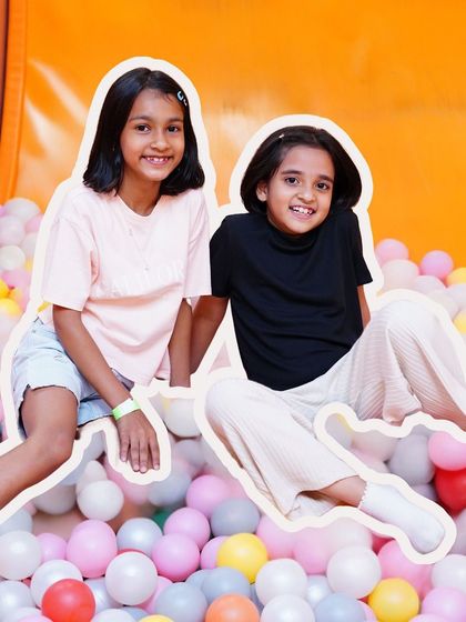 Best friends making memories in the ball pit. Our play area is the perfect spot for playdates and social fun.