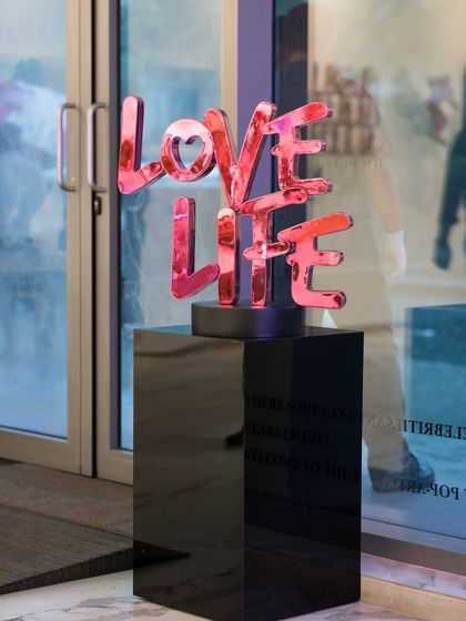 The 'Love Life' sculpture displayed at our gallery entrance. Its reflective surface and positive message create a welcoming and uplifting first impression for our visitors.