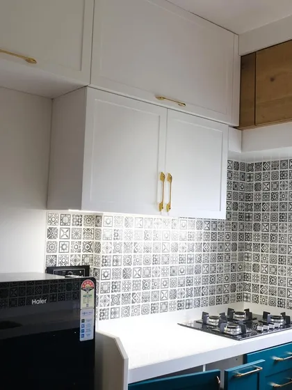 This view highlights the contrast between the white PU upper cabinets and the dark teal lower units, creating a balanced and visually interesting kitchen design.