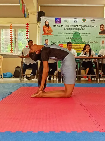 Deepa in a deep backbend, showcasing the flexibility that won her the gold medal.