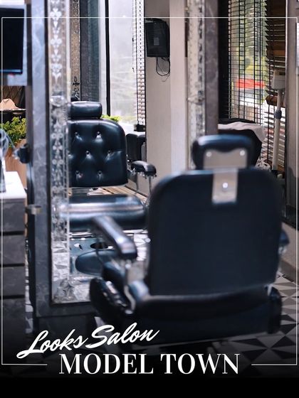 Our dedicated men's grooming section, featuring classic barber chairs and a sophisticated black-and-white aesthetic.