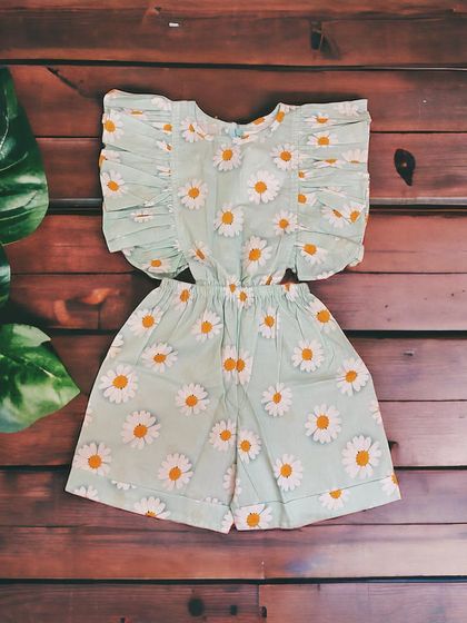 Radiate sunshine in our adorable sunflower jumpsuit! It's perfect for your little fashionista, with charming cut-out waist details and frilly sleeves.