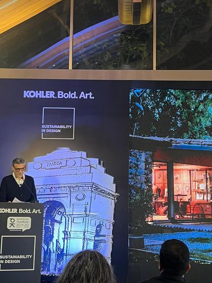 Another view of our principal speaking at the Kohler event, with an image of our biophilic studio in the background. Our own workspace serves as a prime example of our commitment to sustainable design principles.