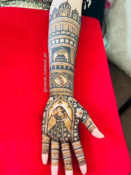 A closer look at a single arm from a bridal portrait set. This image clearly shows the groom's portrait on the palm, framed by floral patterns and topped with architectural dome motifs.