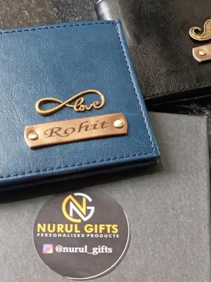 A pair of personalized wallets for 'Rohit' and 'Nitish', featuring the 'love infinity' and mustache charms.