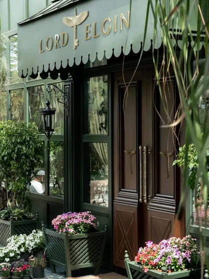 A close-up of the entrance, with its custom wooden doors and brass hardware, hinting at the quality and craftsmanship within.