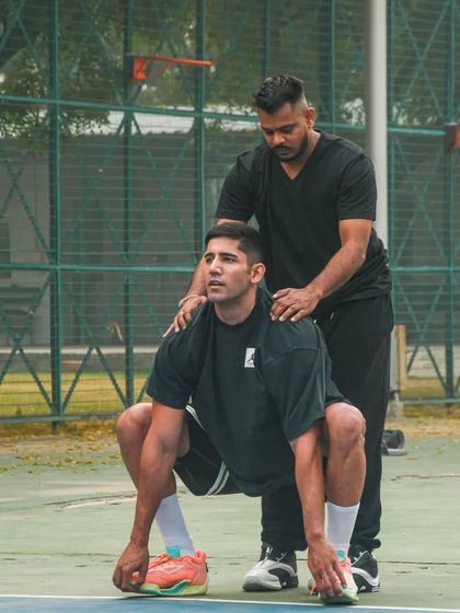 Working on proper squat form to build lower body strength, the engine for any basketball player.