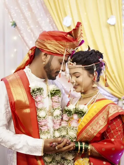 A quiet, intimate moment between the bride and groom amidst the wedding rituals.