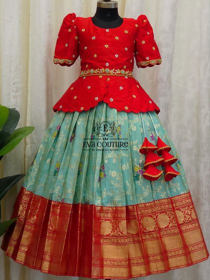 Another view of the red and pastel blue Pattu Pavadai, showing the comfortable fit and flow of the skirt.