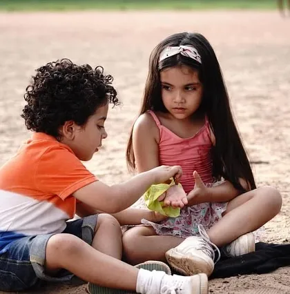A candid shot of the child actors on a Grandiose Productions set, taking a break between scenes.