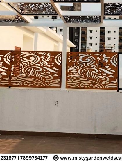 The beautiful rust-colored CNC panels stand out against the white wall, showcasing the artistic element of the pergola design at Natura Atavi. These panels provide both privacy and a stunning visual feature.