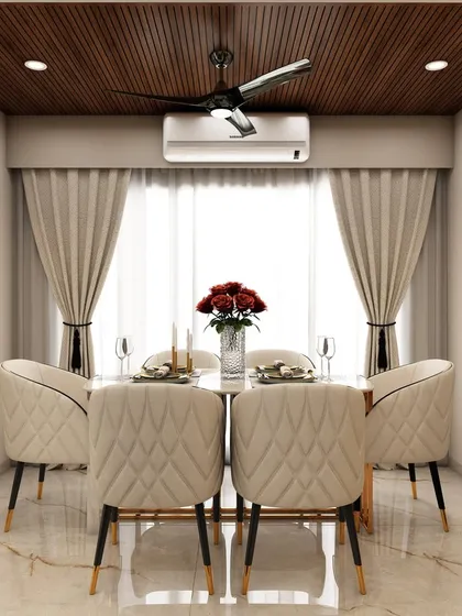 A close-up of the elegant dining area within the same open-plan space, featuring quilted chairs and a wooden ceiling panel that defines the zone while maintaining a cohesive aesthetic.