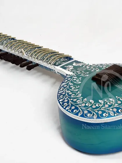 Another angle of the blue rock sitar, showcasing the craftsmanship of the bridge and the intricate patterns on the main body.