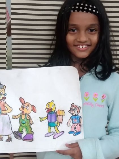 Bhanavi, a 2nd standard student, shows her cartoon drawing made with oil pastels. We encourage students to draw their favorite characters to make learning fun and relatable.