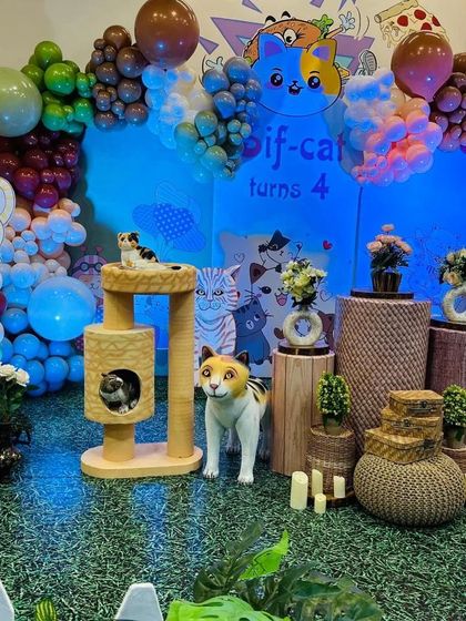 The full cat-themed setup, with a custom backdrop, cat trees, and various cat figurines creating a playful scene.