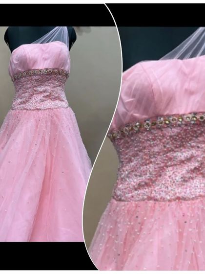 This pretty peach-pink gown features a heavily beaded and sequined bodice for a touch of sparkle. The one-shoulder tulle strap adds a modern, asymmetrical detail.