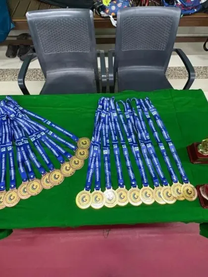 Medals and trophies lined up, ready to be awarded to our hardworking summer camp participants. We believe in recognizing effort and achievement.