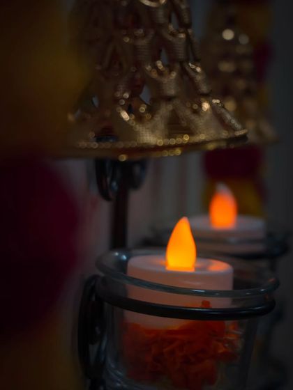 A detailed shot focusing on the warm, ambient light of Diwali. These flameless electronic candles provide a safe and beautiful glow, perfect for creating a festive atmosphere.